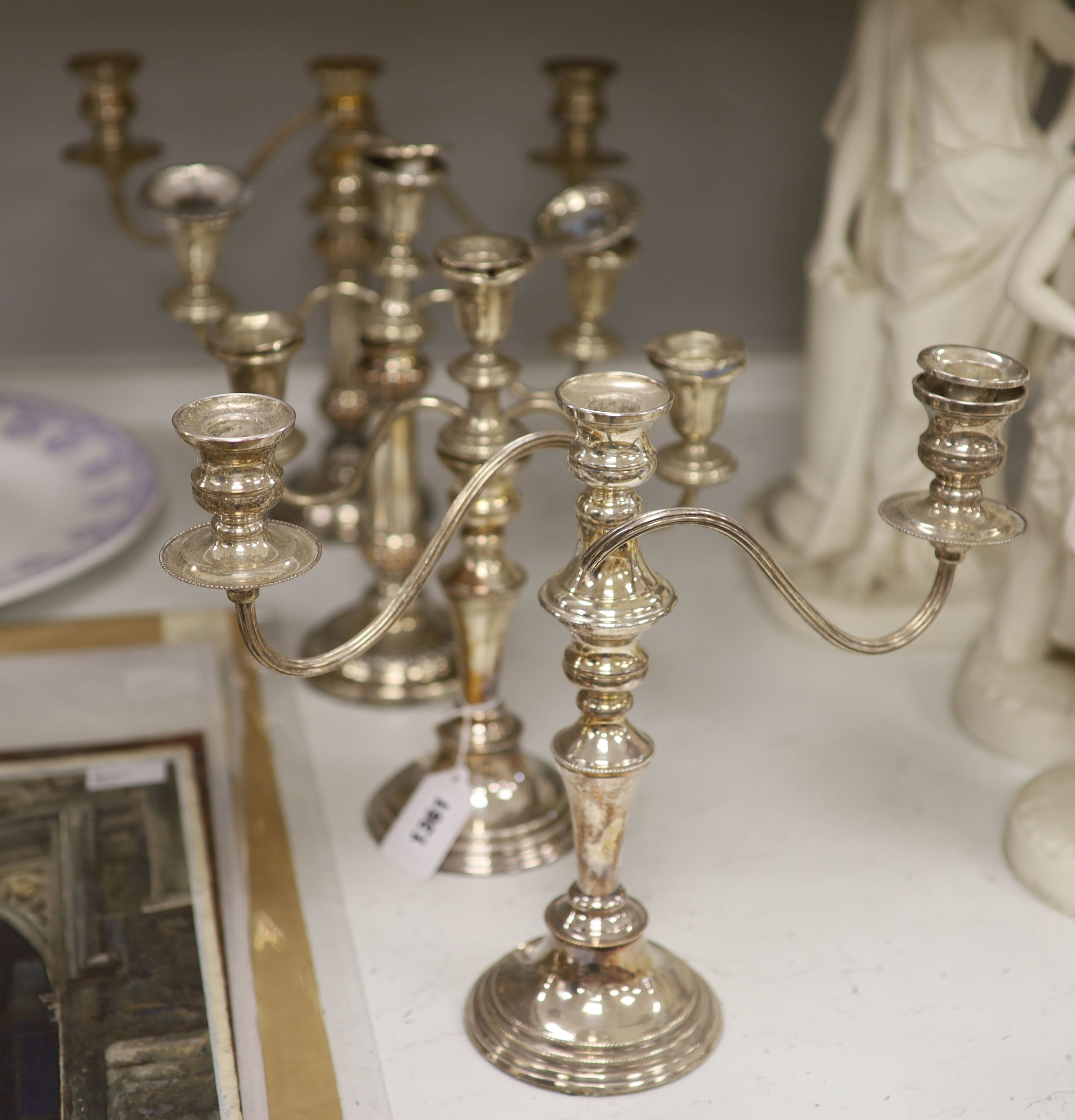 Two pairs of silver plated two branch candelabra, height 30cm